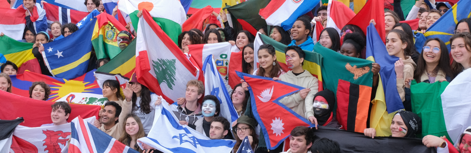 GLE, Global Leadership Experience GLE students waving flags from around the world on the campus of UWC Atlantic