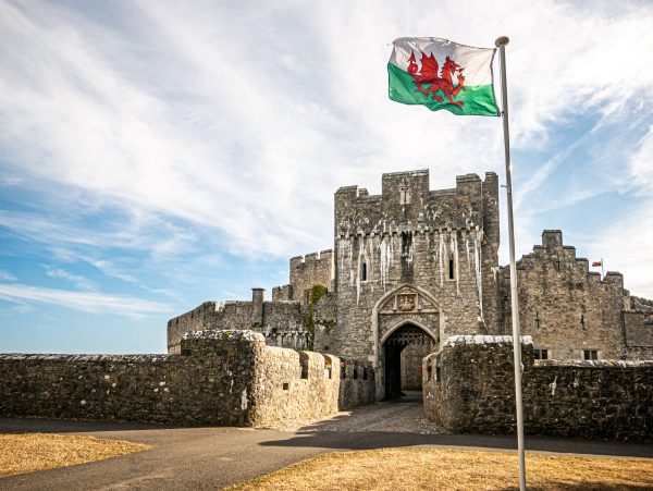 Portcullis entrance to St Donat's Castle with welsh flag flying