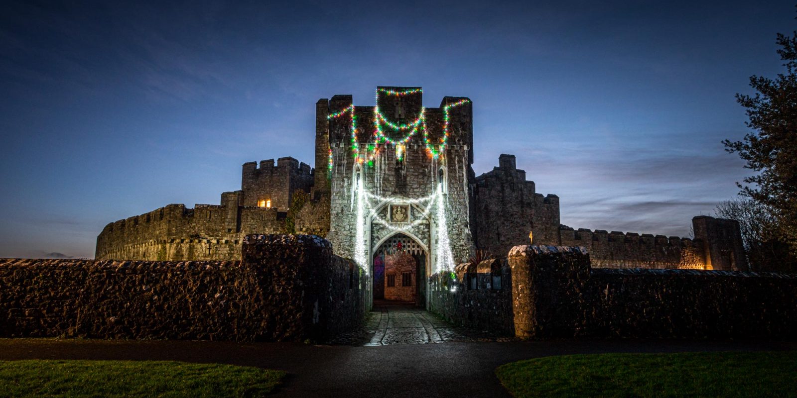 St Donat's Castle with Christmas lights draped at nighttime